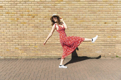 Happy and carefree young woman outdoors - WPEF02986