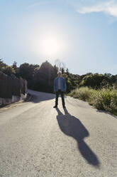 Senior man standing on road, shadow - AFVF06594