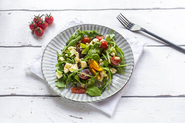 Plate of low carb vegetarian salad with arugula, tomatoes, nuts and Mozzarella cheese - SARF04595