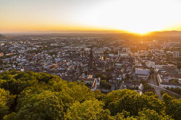 Germany, Baden-Wurttemberg, Freiburg im Breisgau, Sunset over city seen from summit of Schlossberg hill - WDF06019