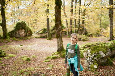 Girl walking through a beech forest - CAVF84619