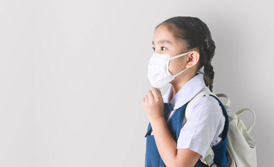 Girl Wearing Surgical Mask While Standing Against White Background - EYF05253