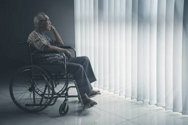 Side View Of Senior Man Sitting On Wheelchair - EYF05317