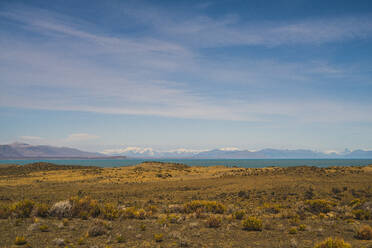 Argentina, Bushy plateau with lake and mountains in distant background - UUF20652