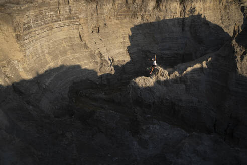 One man trail running down through a ridge on a sandy terrain - CAVF84905