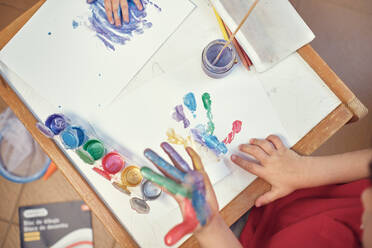 Children playing in an inner courtyard and painting with water paints - CAVF84929