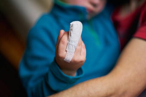 Crop child showing bandaged finger - CAVF85010