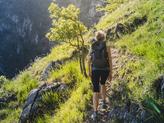 Woman with Backpack Sliding Down on Snow Covered Hiking Trail with  Panoramic View on Snowcapped Mountain Peak Kreiskogel Stock Photo - Image  of recreation, backpacker: 265315204