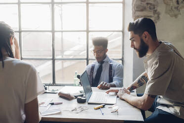 Creative business people working at table in loft office - MEUF00650