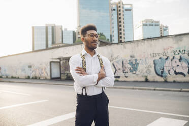 Confident stylish young man standing on the street in the city - MEUF00794