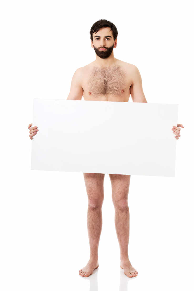 Portrait Of Naked Man Holding Blank Placard Against White Background stock  photo
