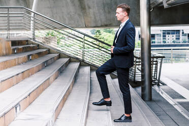 Full Length Of Young Businessman Walking On Staircase - EYF05576