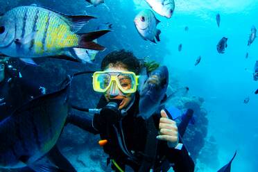 Close-Up Of Woman Scuba Diving In Great Barrier Reef - EYF05583