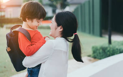 Mother Embracing Son In City - EYF05591