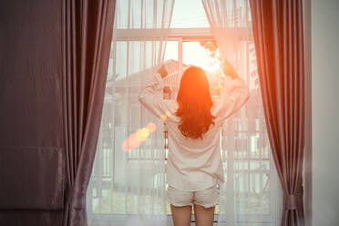 Sexy female underwear model. Young fit woman with white cotton t-shirt and  panties. standing at the window Stock Photo by ©2s 193365204