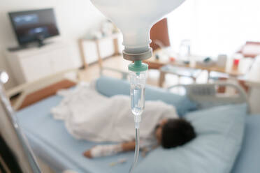 High Angle View Of Patient Lying Down On Bed In Hospital - EYF05630