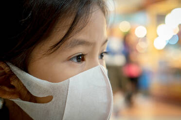 Close-Up Of Cute Girl Wearing Mask At Market - EYF05666