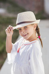 Smiling cute girl wearing hat and white sundress on summer day - LJF01577