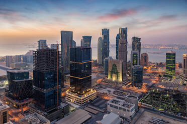 Modern Buildings In City By River Against Sky During Sunset - EYF05891