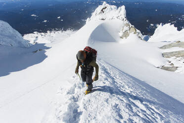 A man climbs to the summit of Mt. Hood in Oregon. - CAVF85329