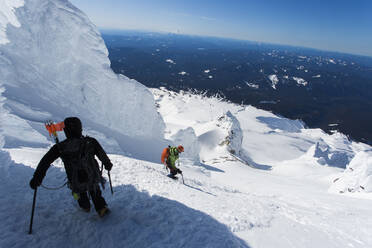 Two men climb down from the summit of Mt. Hood in Oregon. - CAVF85333