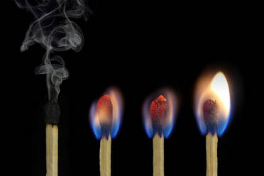 Close-Up Of Matchsticks Against Black Background - EYF05955