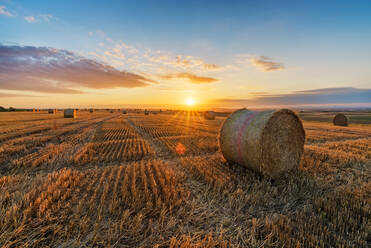 Hay Bales On Field Against Sky During Sunset - EYF05984