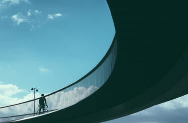 Low Angle View Of Man On Bridge Against Sky - EYF06167