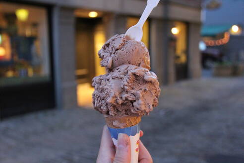 Cropped Image Of Person Holding Chocolate Ice Cream Cone - EYF06323