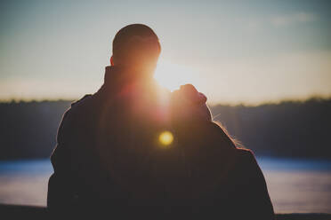 Rear View Of Couple Watching Sunset - EYF06338