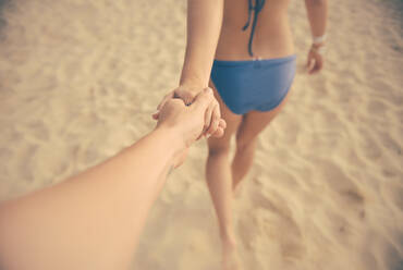 Cropped Image Of Couple Holding Hands At Beach - EYF06339