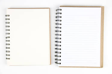 Directly Above Shot Of Spiral Notebooks On White Background - EYF06399