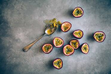 High Angle View of Passion Fruits By Spoon On Table - EYF06445