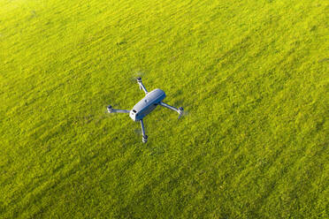 Germany, Bavaria, Icking, Drone flying over green countryside meadow - SIEF09895