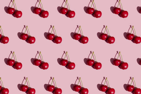 Pattern of fresh cherries on pink background - GEMF03873