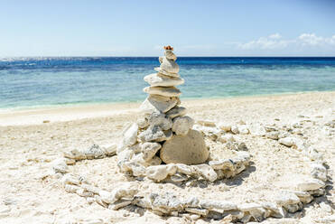 Coral stacked on Lady Elliot Island against sky, Queensland, Australia - KIJF03100