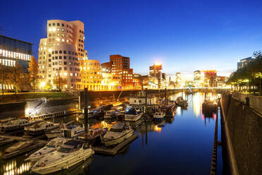 Germany, North Rhine-Westphalia, Dusseldorf, Boats moored in city canal at dusk - PUF01905