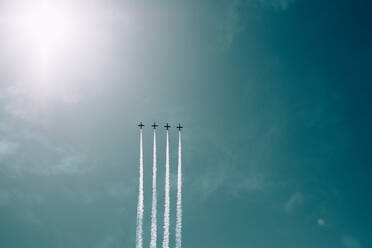 Low Angle View Of Airplanes Flying Against Blue Sky - EYF06507