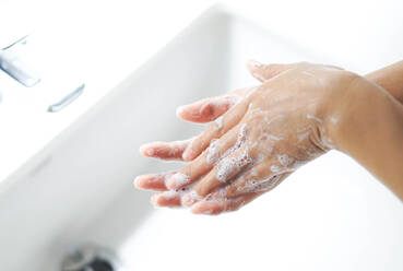 Cropped Image of Woman Washing Hands In Sink At Bathroom - EYF06530