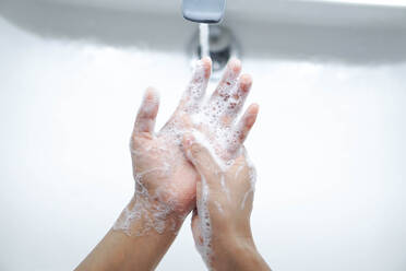 Cropped Image of Person Washing Hands In Sink - EYF06534