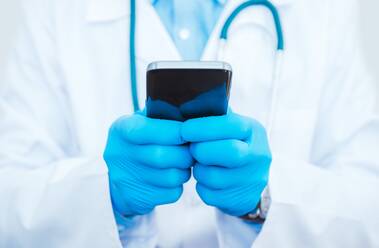 Midsection Of Doctor Using Mobile Phone - EYF06554