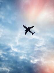 Low Angle View of Airplane Flying In Cloudy Sky - EYF06790