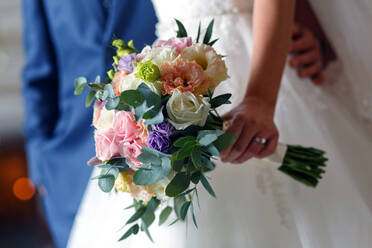 Midsection Of Bride Holding Bouquet - EYF07015