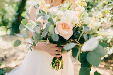 Midsection Of Bride Holding Flower Bouquet - EYF07057