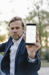 Close-up of businessman holding smartphone - JOSEF00934