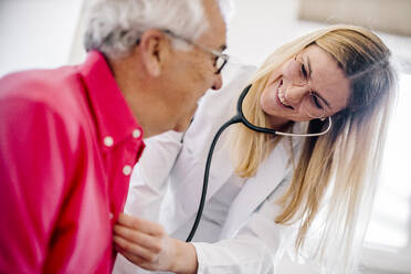 Ärztin bei der Untersuchung eines älteren Patienten in einer medizinischen Klinik - DAWF01650