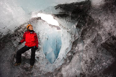 Woman exploring ice cave on Sólheimajökull glacier in south Iceland - CAVF85689