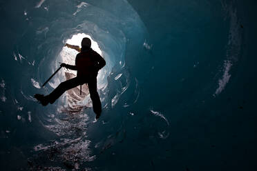 Woman exploring ice cave on Sólheimajökull glacier in south Iceland - CAVF85690