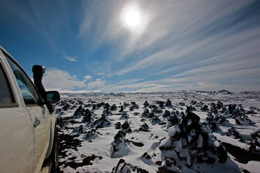 SUV driving through snowy landscape in the Icelandic highlands - CAVF85719