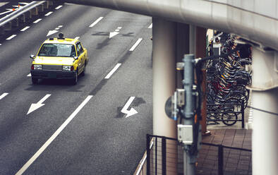 Japan, Osaka Prefecture, Osaka, Old-fashioned taxi driving along city street - EHF00346